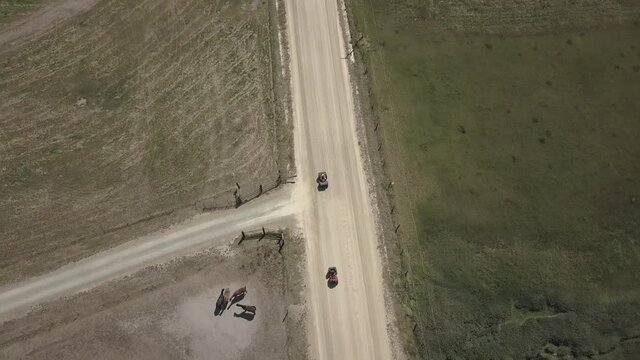 Aerial Drone View Tracking ATVs on Dirt Road Directly Above In Front