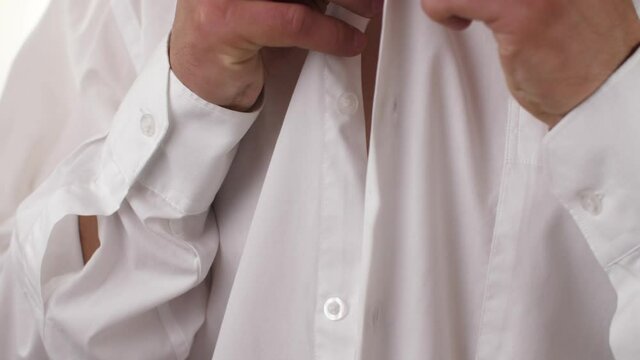 Man hide microphone under shirt