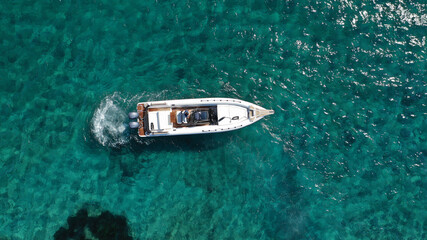 Aerial drone photo of luxury inflatable speed boat cruising in deep blue Aegean sea, Mykonos island, Cyclades, Greece