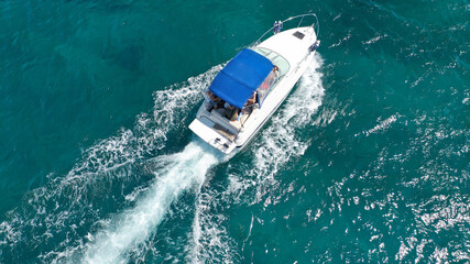 Fototapeta premium Aerial drone photo of luxury power boat cruising in deep blue sea near Mediterranean Aegean island
