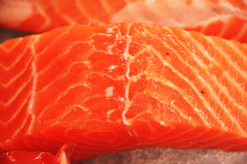 Fresh red salmon fillets and fatty strands inserted between the meat. Slides are beautifully sized pieces that are appetizing.