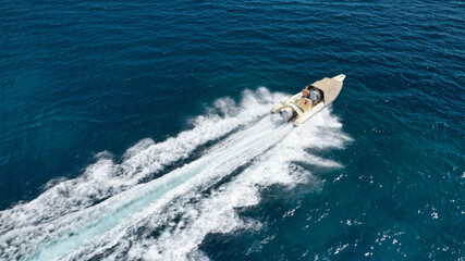 Aerial drone photo of luxury inflatable speed boat cruising in deep blue Aegean sea, Mykonos...