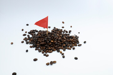 Coffee beans with a mini flag on a white background 