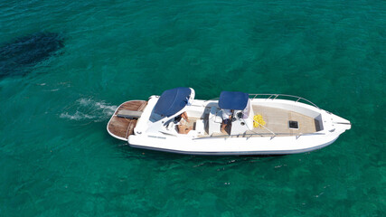 Aerial drone top down photo of luxury inflatable rib boat anchored in tropical exotic bay with emerald sea