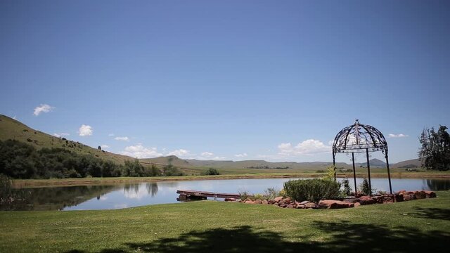 A wide shot of a calm trout dam in the mountains of Mpumalanga, South Africa