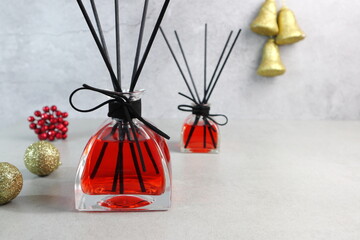 colorful nice scent aroma reed diffuser glass bottles are displayed  on the grey table with background of cement wall during merry christmas and happy new year party celebration festival winter season