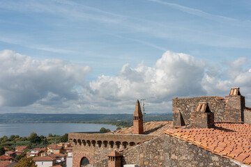 View from the Castle of Bolsena. Lake and rooftops under blue sky. Viterbo, Italy. 
