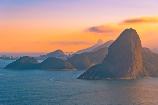 Sugarloaf Mountain from Behind during Red Sunset with View of Hills and Ocean, Rio de Janeiro, Brazil