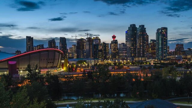 Day to night timelapse view of Calgary skyline showing high rise buildings in the financial district, Calgary, Alberta, Canada, zoom out. 