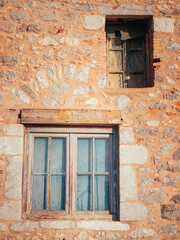 Fototapeta na wymiar Vintage wooden windows on stone house, soft light