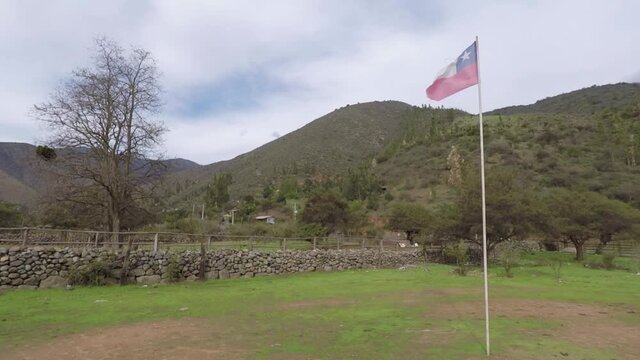 Chilean flag waving in the field between hills.
Bandera Chilena flamenado en el campo entre monta&ntilde;as