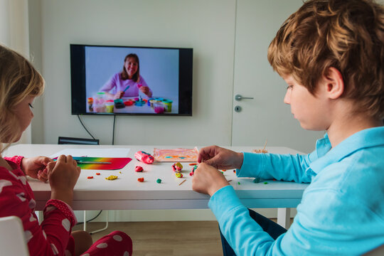Boy and girl making crafts during online lesson