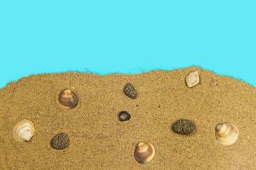 sand and stones, seashell on blue background