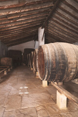 Wine barrels stacked in the old cellar of the vinery in Spain