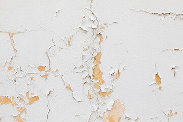 white old paint is peeling of a wall but gives an harmonic symbol