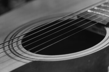 Details of an acoustic guitar, detailed photos of a guitar, guitar strings and soundhole, abstract, blurring, macro photo, black and white photo