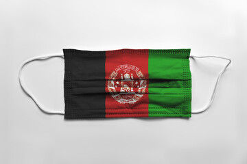 Face mask with Afghanistan flag printed, on white background, isolated