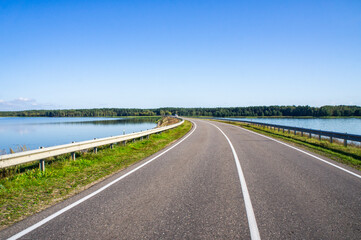 A beautiful automobile asphalt road without cars and people.