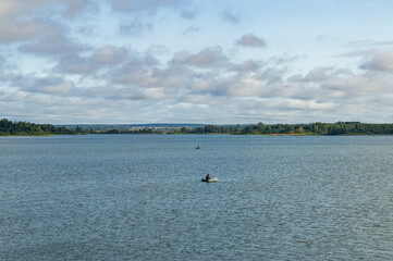 Boat with a fisherman in a big lake