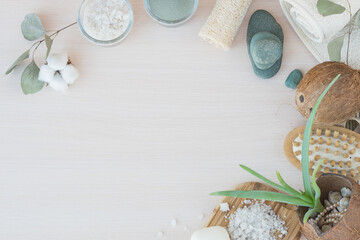 Beauty and fashion concept with spa setting. composition with Dead sea salt, coconut,  natural cosmetic blue clay,  soda, loofah. Flat lay, Spa concept with cotton flower, stones and towel.