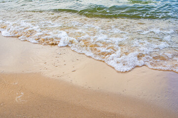 Fototapeta na wymiar Transparent sea wave on a clean sandy seashoreа