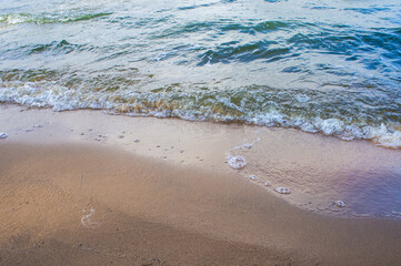 Transparent sea wave on a clean sandy seashoreа