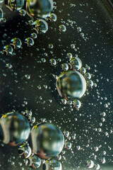 Small bubbles of vegetable oil in water close-up.