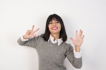 Young  businesswoman with retro short hair wearing casual clothes standing over isolated white background  showing and pointing up with fingers number eight while smiling confident and happy.