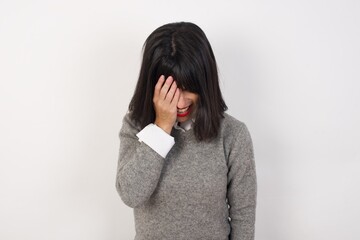 Young  businesswoman with retro short hair wearing casual clothes standing over isolated white background  Yawning tired covering half face, eye and mouth with hand. Face hurts in pain.