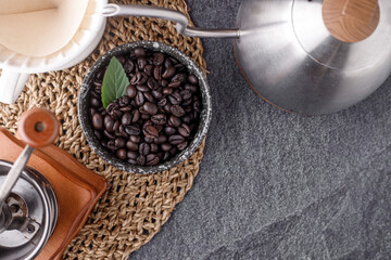 Coffee cup with roasted beans on stone background. Top view with copy space
