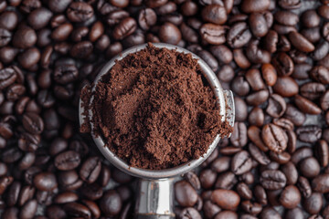 Filter holder with ground coffee and roasted coffee beans .