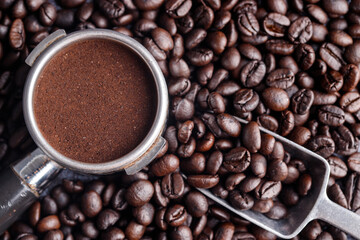 Filter holder with ground coffee and roasted coffee beans .