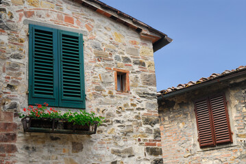 Fototapeta na wymiar Stone buildings and shuttered windows in San Donato in Poggio Tuscany Italy