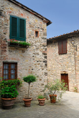 Fototapeta na wymiar Stone buildings in small piazza in San Donato in Poggio Tuscany Italy