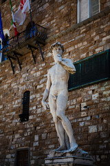 The Italian Renaissance sculpture of The David created in marble by the Italian artist Michelangelo in Florence, Tuscany, Italy. Close up street view. European art and outdoor decor.