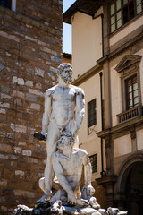 The marble sculptures of Hercules and Cacus created by Michelangelo in Florence, Tuscany, Italy. Original name: "Ercole e Caco". White stone statues of the demi-gods on a European street.