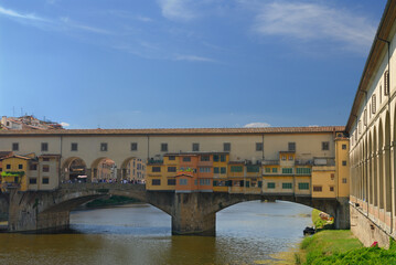 Fototapeta na wymiar Old shops hanging on the Ponte Vecchio bridge over the Arno river in Florence