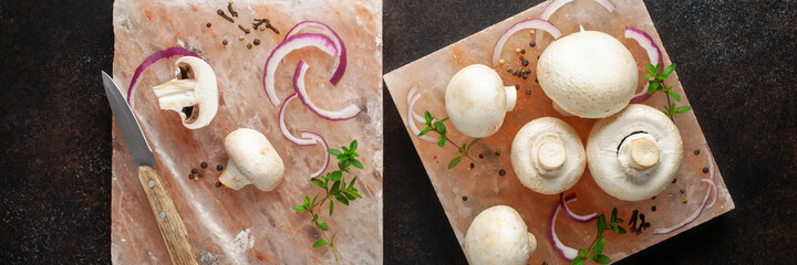 Raw mushrooms champignon on a Himalayan salt block with grilling spices. Top view. Banner