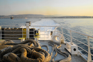 Ship wake and thick rope looking back towards city
