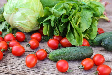 Vegetables and greens on a wood background
