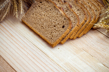 Whole wheat bread. Fresh loaf of rustic traditional bread with wheat grain ear or spike plant on...