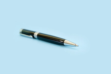 black ballpoint pen on a blue background.