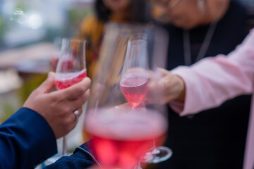 Close up shot of group of people toasting glasses filled with champagne