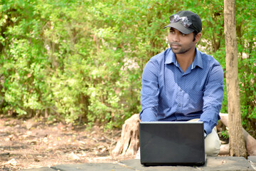 Indian handsome businessman with laptop outdoor