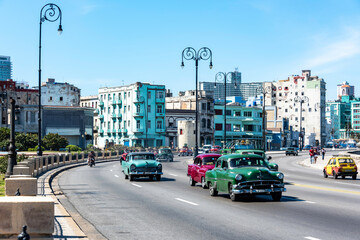 Vintage classic cars driving on the outskirts of Havana Cuba