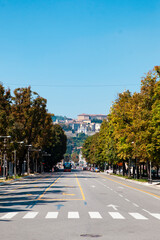 Fototapeta premium Bergamo, Lombardy / Italy - September 01, 2020 - Urban view. Classic Italian street in the middle of the city center with cars, trees, vintage buildings. European architecture.