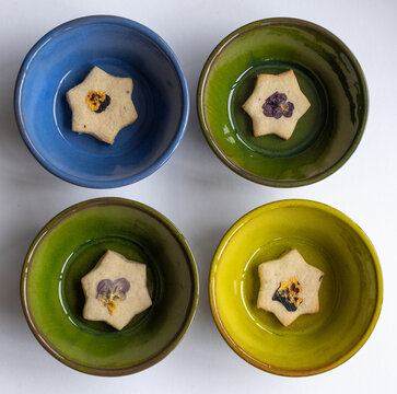 Star Shaped Biscuits Decorated With Edible Flowers, Pansies And Cornflower Petals. 