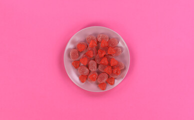 marmalade on plates isolated on red background