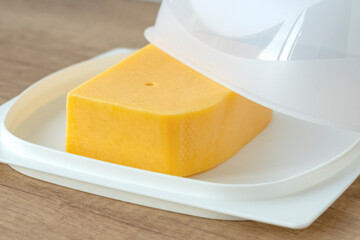 cheese pan.Cheese storage item. Concept of storing cheese in the refrigerator.