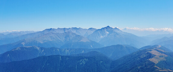 view of high mountains to the horizon from one of the peaks